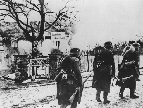 German troops pass through a village during the invasion of Norway.